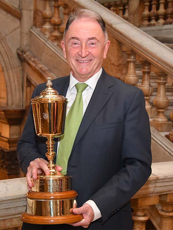 Sir Jim holding the Loving Cup.