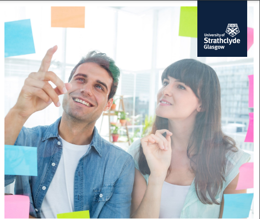 Two poeple looking at sticky notes with the University of Strathclyde logo on the top right