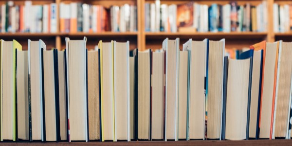 Books lined up on a shelf Books lined up on a shelf