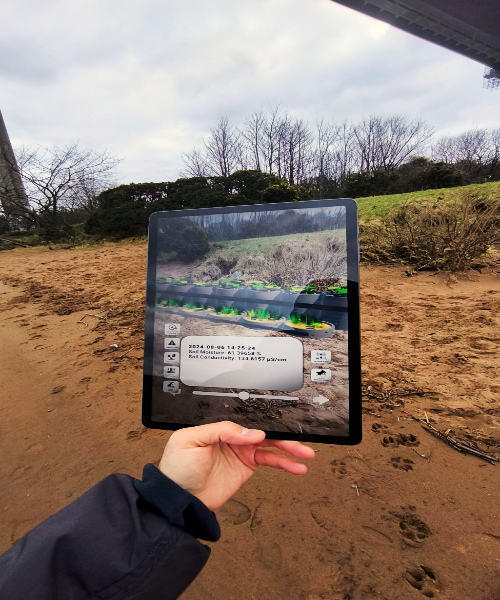 Hand holding ipad which is scanning the environment