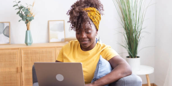 A girl sitting using a laptop