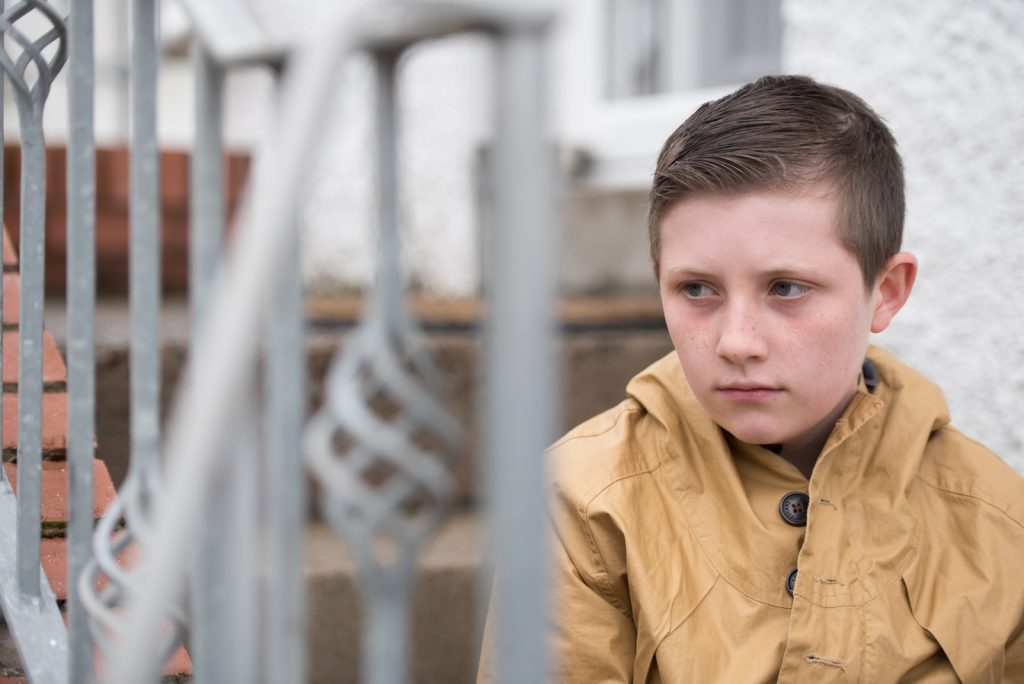 A young boy lookign worried