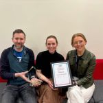 Three team members holding UCISA award