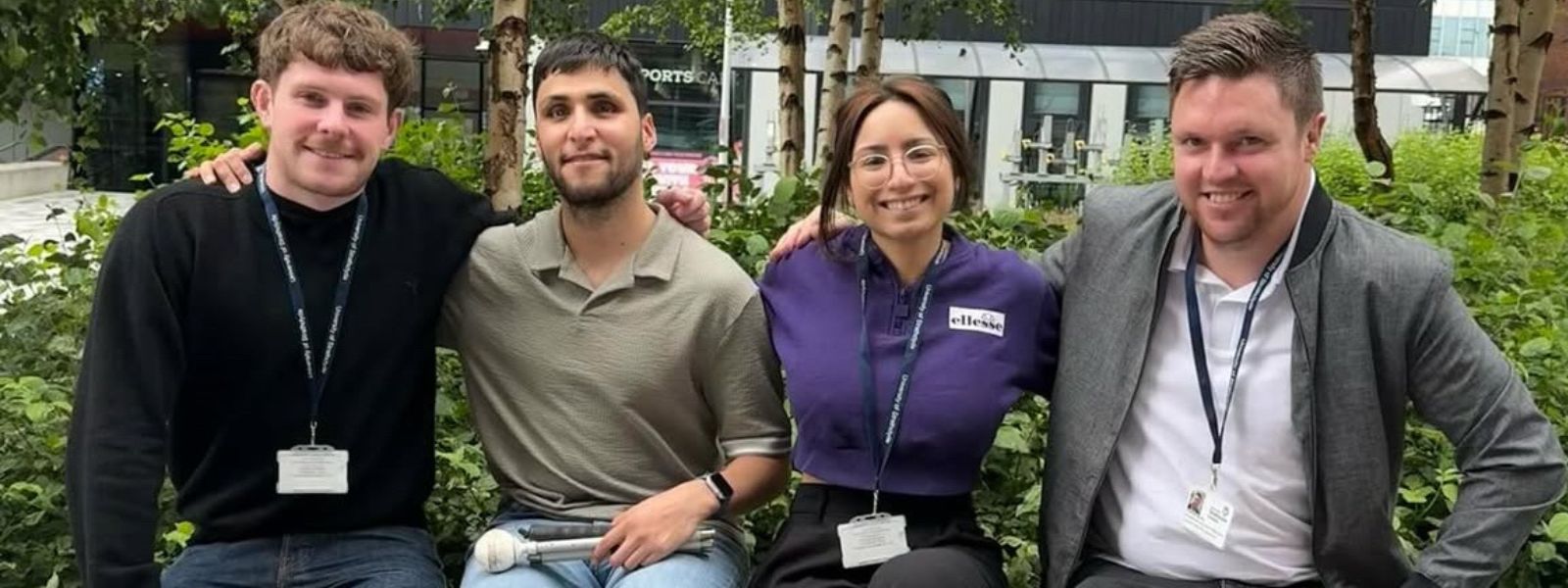 4 Project Assistants sitting on a bench